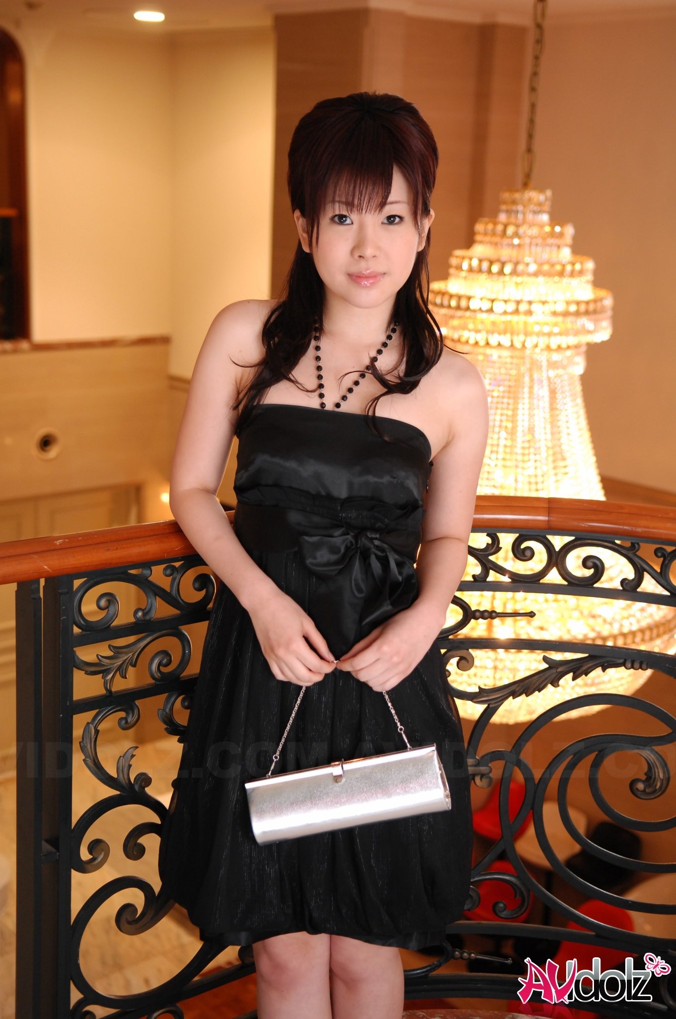 Beautiful Hina Kawamura in black dress enjoys a glass of champagne.